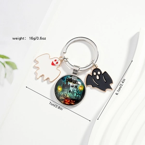Halloween keychain detail showing glass dome charm with castle and ghost pendants