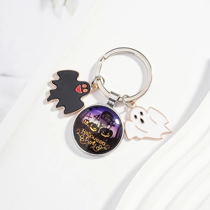 Halloween keychain with black and white ghosts and a pumpkin glass charm for keys