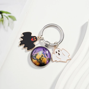 Detail of Halloween keychain with castle glass dome and cartoon ghost enamel charms