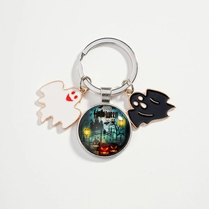 Halloween keychain with green castle glass dome and cute black and white enamel ghosts
