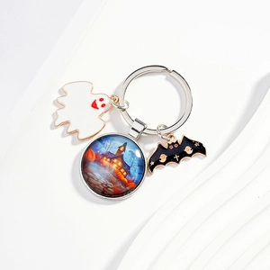 Halloween keychain featuring blue castle glass ball, white ghost, and black bat pendant
