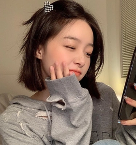 Detailed view of heart-shaped checkerboard hair claw clip styled on woman's side hair