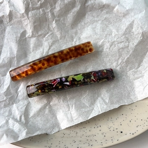 Close-up of elegant acetate hair clips with tortoiseshell and floral patterns