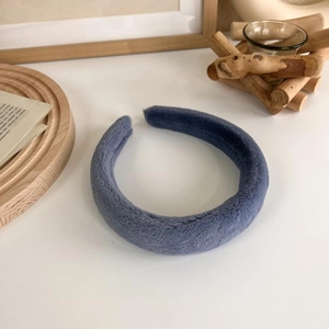 Gros plan du serre-tête en peluche bleue avec texture douce et design rembourré