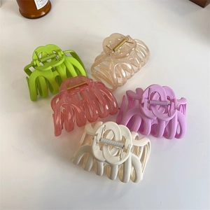 Macro detail of various large hair claw clips with interlocking design in five matte colors