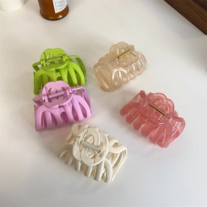 Five assorted vintage claw clips in matte and glossy finishes for thick hair