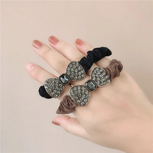 Detail of elegant fabric scrunchies with crystal rhinestones and bow design