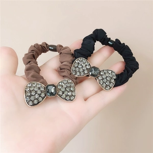 Close-up of bow hair ties featuring sparkling rhinestones and a central rectangular gem