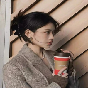 Oversized acetate bow hair claw and jewelry set on model in brown wool blazer