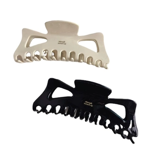 Set of large acetate bow hair claws in beige and black colors for women's hair styling