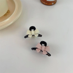 Set of small acrylic bow hair claws in pastel pink and cream white colors for women