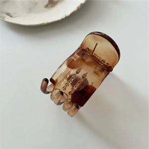 Detailed close-up of a tortoiseshell claw clip made of translucent amber resin