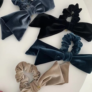 Set of four velvet bow hair scrunchies in blue, black, green and gold with gold buckles