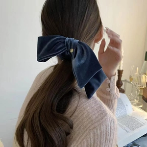 French vintage dark blue velvet bow hair scrunchie with gold emblem on ponytail