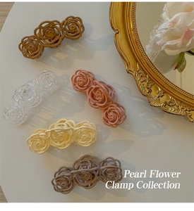 Detailed view of elegant hollow rose hair clamps in various matte and clear colors