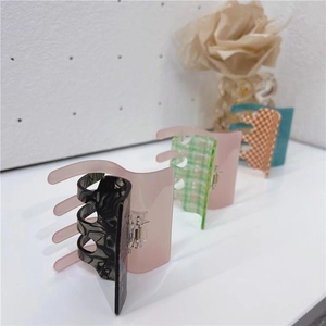 Large acetate claw clips set in marble and checkerboard patterns for elegant hairstyles
