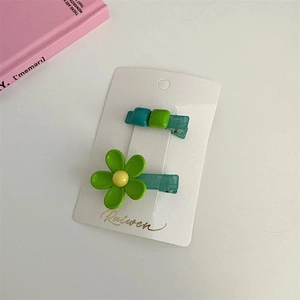 Green floral and geometric hair clip set in pastel tones on display card