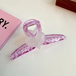 Macro shot of large purple translucent heart hair claw with strong metal spring detail