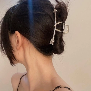Silver metal cupid arrow hair claw clip for women shown on model for elegant hair styling