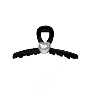 Close-up of matte black hair claw clip featuring a metallic silver heart ornament