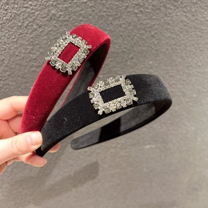 Detail of luxury velvet headband with sparkling rectangular rhinestone buckle in deep red