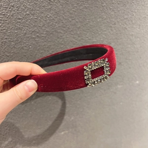 Detail of burgundy velvet wide headband with a sparkling rectangular crystal buckle