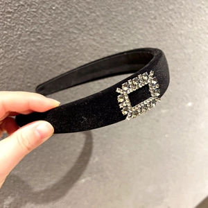 Close-up of luxury velvet wide headband with sparkling crystal rectangle buckle detail