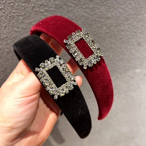 Detailed view of wide velvet headbands in black and wine red with crystal square buckle