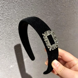 Luxurious black velvet wide headband with a sparkling champagne rhinestone buckle detail