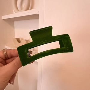 Detail of large dark green velvet square hair claw clip with elegant flocked texture
