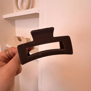 Close-up of a large square dark brown velvet hair claw clip with a matte non-slip texture