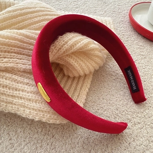 Vintage red velvet padded headband with gold metal accent and handmade label detail