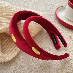 Set of two vintage red velvet padded headbands with gold accents on knit background
