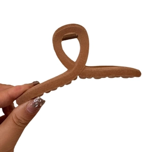 Elegant dark brown velvet hair claw clip with a stylish cross-winding design for women