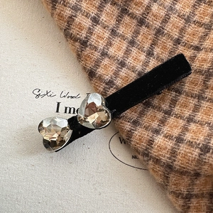 Elegant black velvet hair clip with two heart-shaped crystals in a stylish design