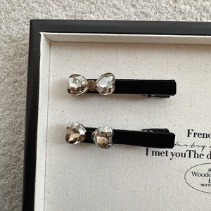 Elegant set of two black velvet hair clips with crystal heart rhinestones for women