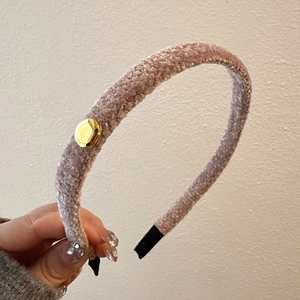 Elegant plush pink headband with golden accent and high-volume top design for women
