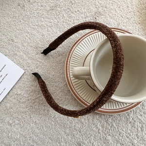 Detailed close-up of coffee brown plush teddy fabric headband for autumn and winter