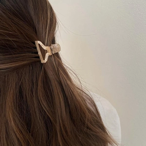Minimalist cream marble acetate triangle hair claw clip on brown hair
