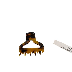 Elegant tortoiseshell acetate hair claw clip with a geometric hollow design on white background