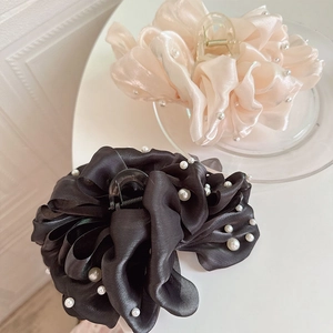 Vue détaillée des pinces à cheveux nuage avec perles élégantes en noir et rose champagne