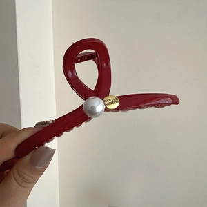 Festive red shark hair claw clip with white pearl and gold engraved believe tag