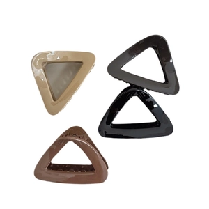 Set of four minimalist triangular hair claws in beige, grey, black and brown colors