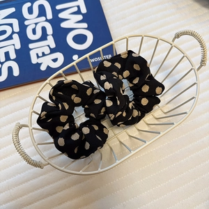 Elegant satin polka dot hair scrunchies set in a minimalist white basket display