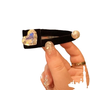 Elegant black velvet hair clip with white pearls and a heart-shaped crystal stone