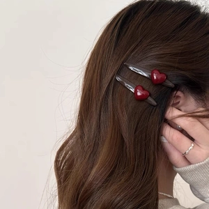 Minimalist red heart hair clips for women shown on long wavy hair in a 2-piece set
