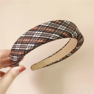 Detail of wide padded headband with classic brown plaid pattern and soft inner lining