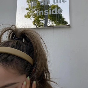 Minimalist light brown PU leather wide headband and elastic hair tie on a woman