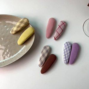 Close-up of set of eight candy colored plaid and solid fabric wrapped BB hair clips