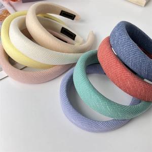 Macro detail of thick padded sponge headbands showing various colors and twill texture